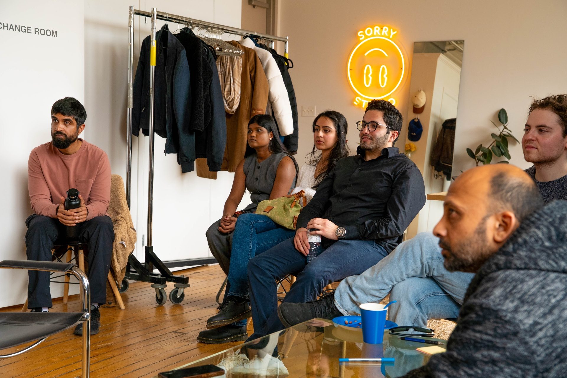 Group listening attentively at Sorry Studio